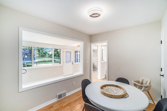 dining space featuring light wood-type flooring