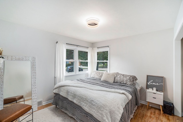 bedroom with wood-type flooring