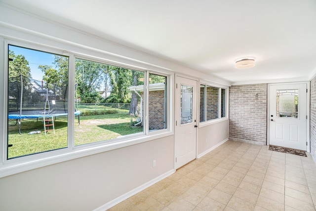 unfurnished sunroom featuring plenty of natural light