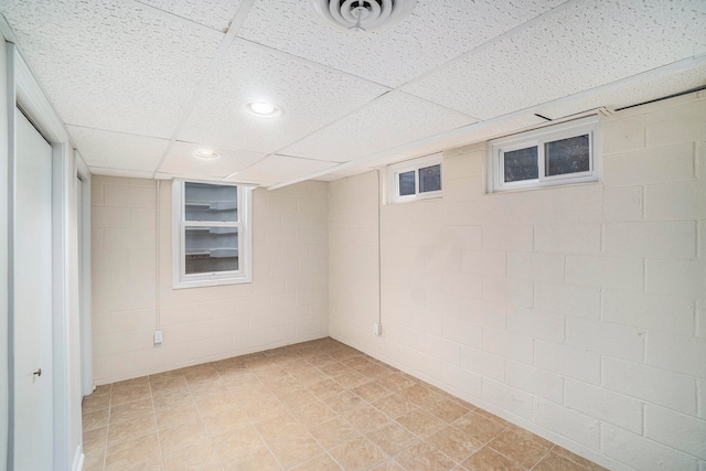 basement with a paneled ceiling