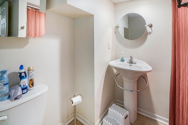 bathroom featuring tile patterned flooring and toilet