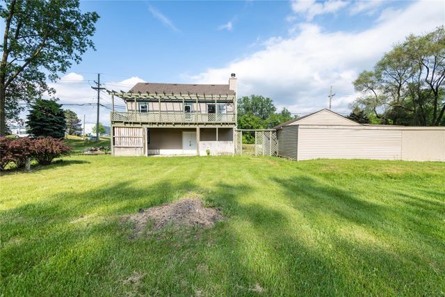 back of house with a yard and a wooden deck