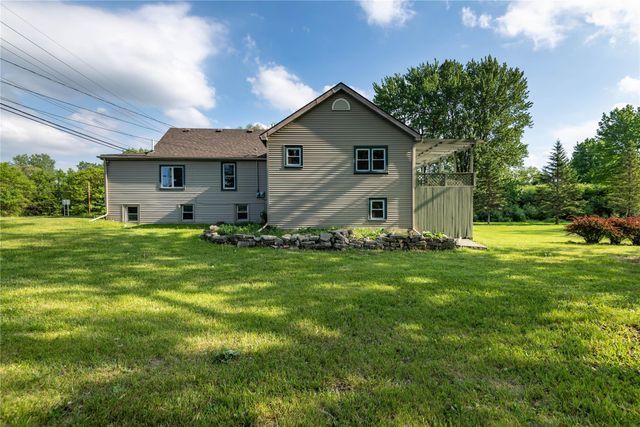 back of property featuring a lawn