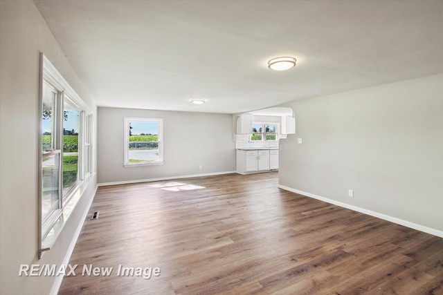 unfurnished living room with wood-type flooring