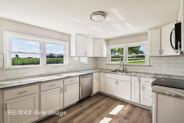 kitchen with white cabinetry, a wealth of natural light, sink, and appliances with stainless steel finishes