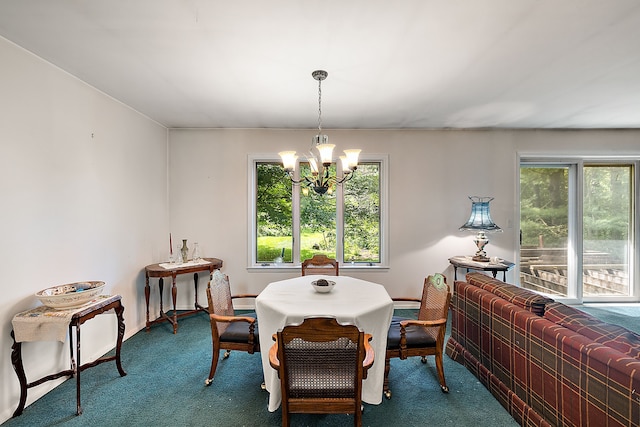 carpeted dining room with a chandelier