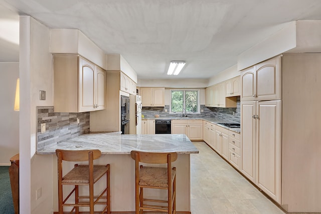 kitchen with black appliances, decorative backsplash, light stone countertops, kitchen peninsula, and a breakfast bar area