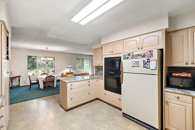 kitchen featuring tasteful backsplash, kitchen peninsula, a chandelier, and black appliances