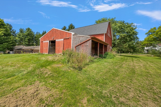 view of outbuilding featuring a yard