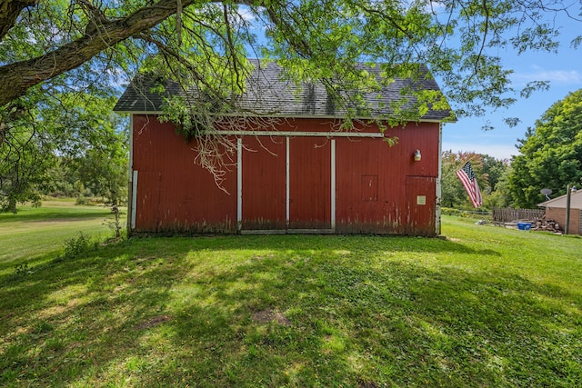 view of outbuilding featuring a yard