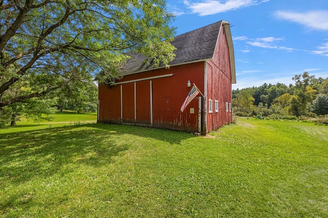 view of outbuilding with a lawn