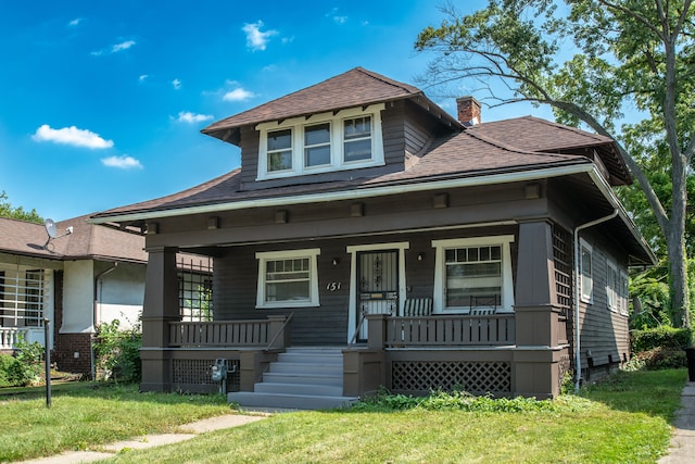 bungalow featuring a porch and a front yard