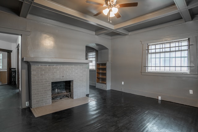 unfurnished living room with a healthy amount of sunlight, dark hardwood / wood-style flooring, and coffered ceiling