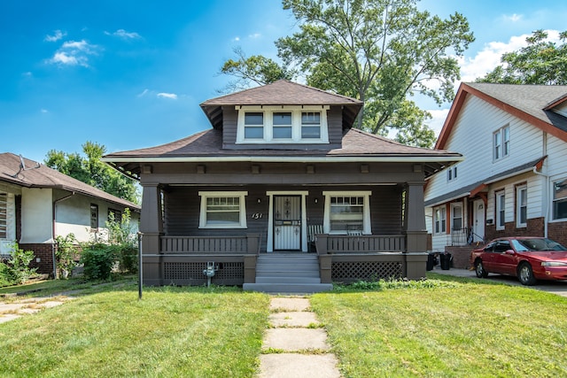 bungalow-style home featuring a porch and a front lawn