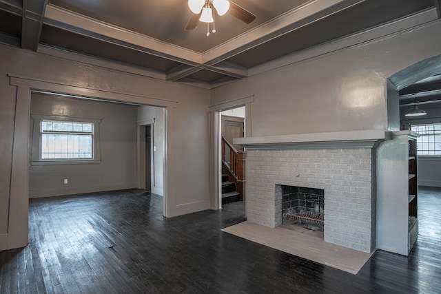 unfurnished living room with beam ceiling, dark hardwood / wood-style flooring, and coffered ceiling