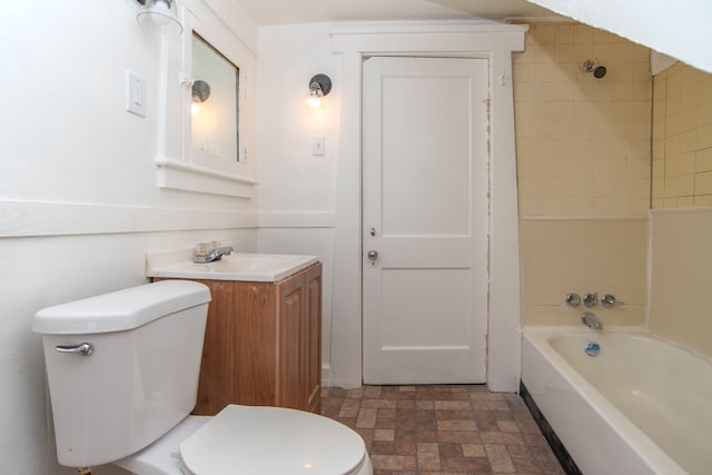 full bathroom with vanity, tiled shower / bath combo, and toilet