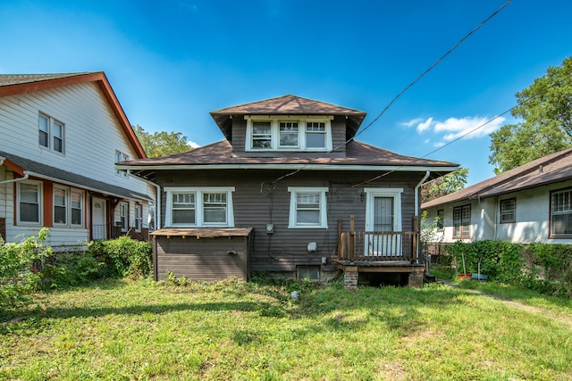 rear view of property with a lawn