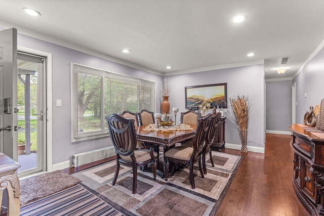 dining space with crown molding and dark hardwood / wood-style floors