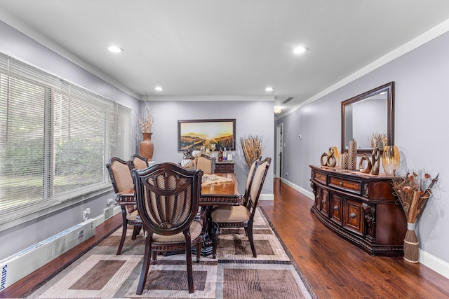 dining room featuring crown molding and dark hardwood / wood-style flooring