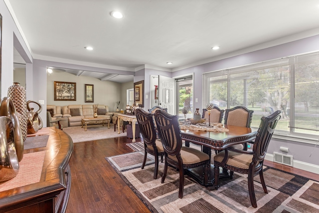 dining area featuring beamed ceiling and dark wood-type flooring