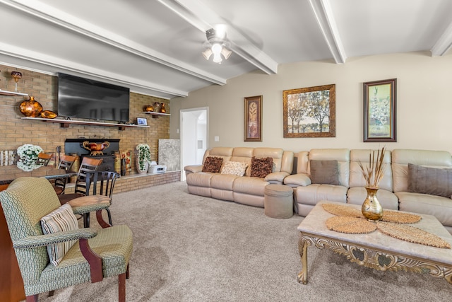 carpeted living room with ceiling fan, beam ceiling, and brick wall