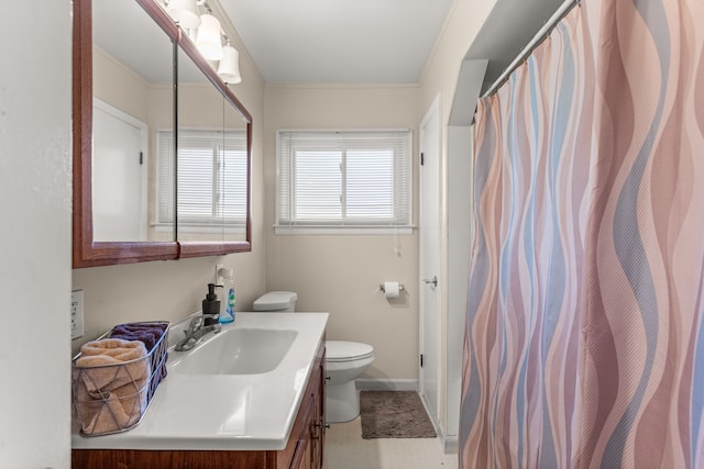 bathroom featuring vanity, toilet, and crown molding