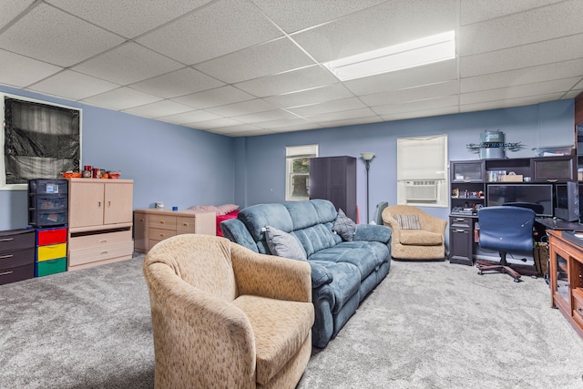 carpeted living room featuring a drop ceiling and cooling unit