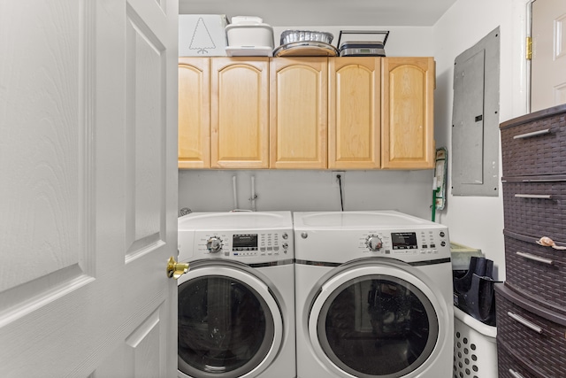 laundry area with separate washer and dryer, electric panel, and cabinets