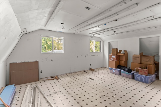 additional living space featuring lofted ceiling