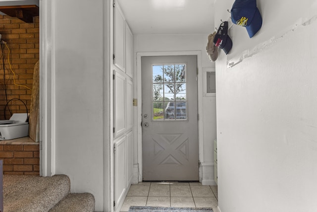 doorway to outside with light tile patterned floors