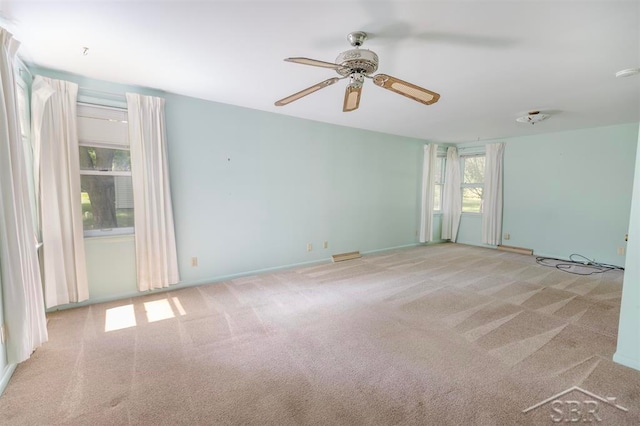 carpeted empty room with ceiling fan