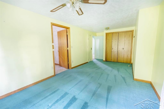 unfurnished bedroom featuring ceiling fan, a closet, and light colored carpet