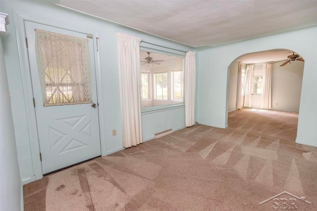 interior space with ceiling fan and light colored carpet