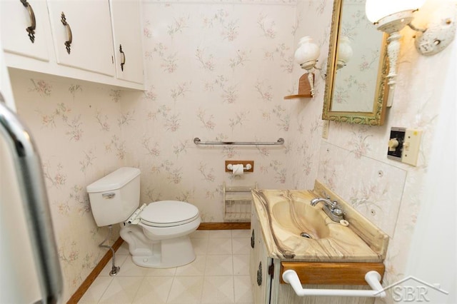 bathroom featuring tile patterned floors, vanity, and toilet