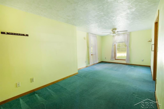 carpeted spare room with ceiling fan and a textured ceiling