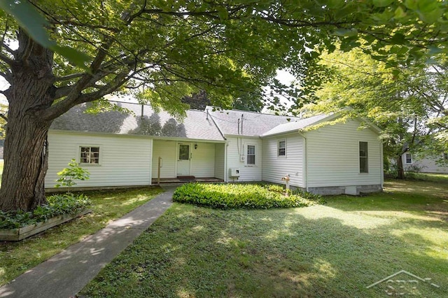 rear view of house with a lawn