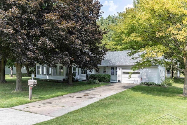 view of front of property featuring a front yard and a garage