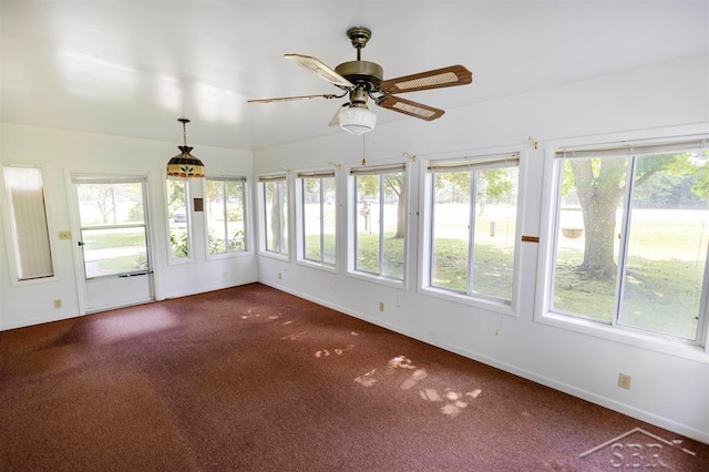 unfurnished sunroom with ceiling fan