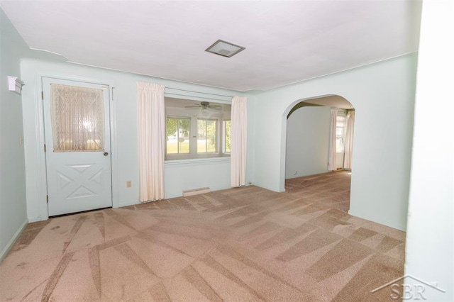 carpeted empty room featuring ceiling fan