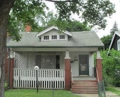 13581 Mendota St, Detroit, MI 48238 - view of front of house with covered porch and a chimney
