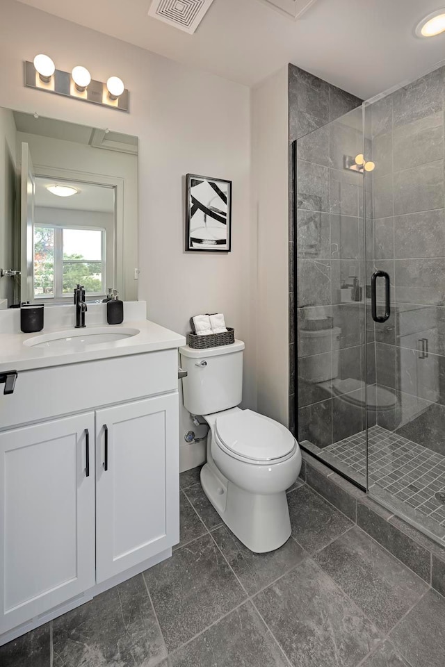 bathroom featuring vanity, toilet, and walk in shower