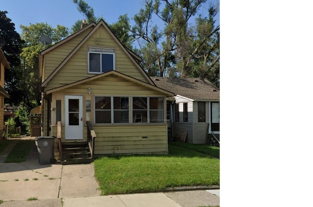 bungalow-style home with a front yard