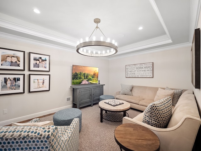 living room with a raised ceiling, ornamental molding, and a notable chandelier