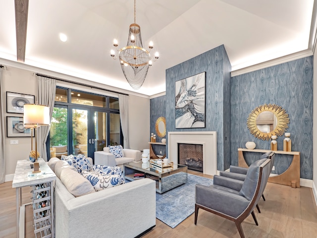 living room featuring french doors, an inviting chandelier, a high end fireplace, lofted ceiling, and light wood-type flooring