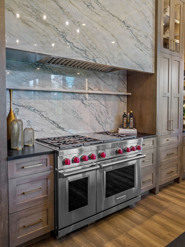 kitchen with decorative backsplash, double oven range, and dark wood-type flooring