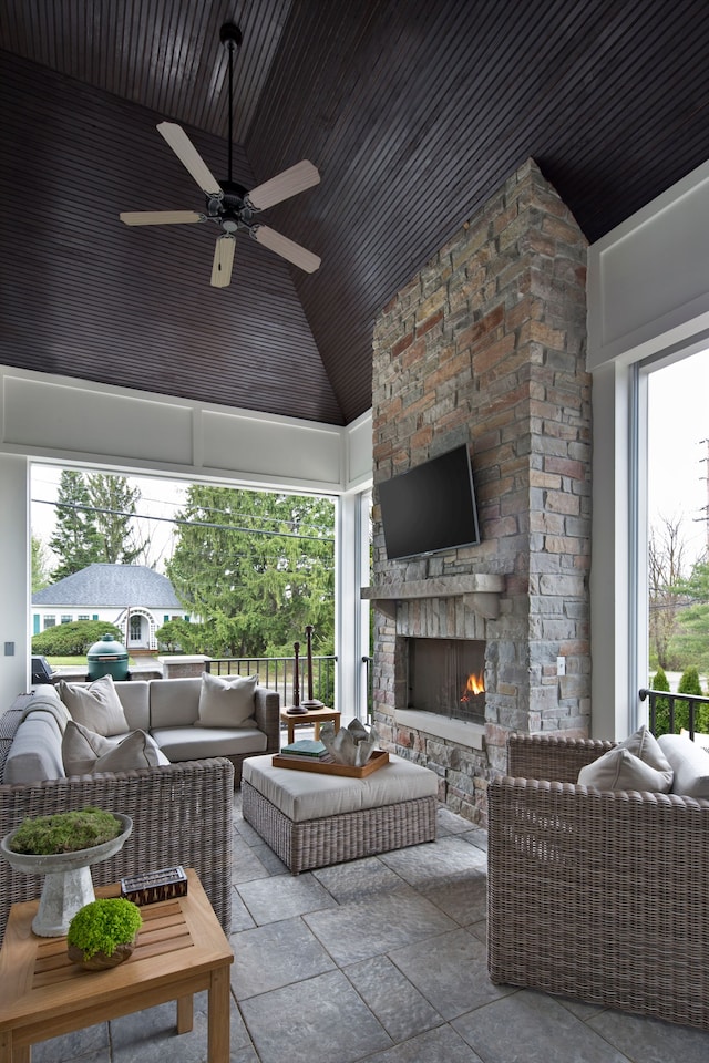 view of patio featuring an outdoor living space with a fireplace and ceiling fan