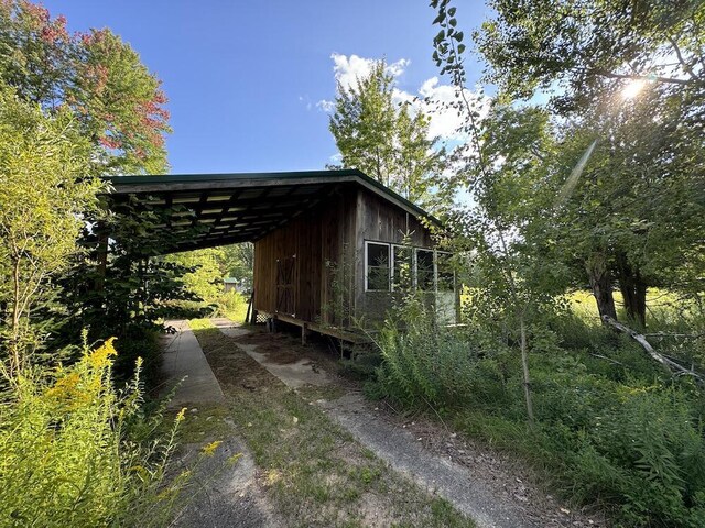 5490 S Harrison Rd, Houghton Lake, MI 48629 - view of property exterior featuring a carport