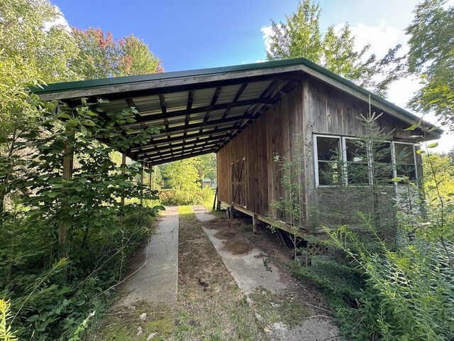 5490 S Harrison Rd, Houghton Lake, MI 48629 - view of parking with a carport