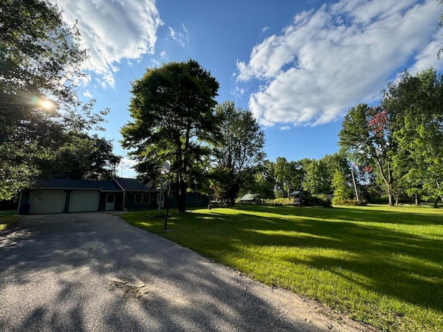 exterior space featuring a garage and a front lawn