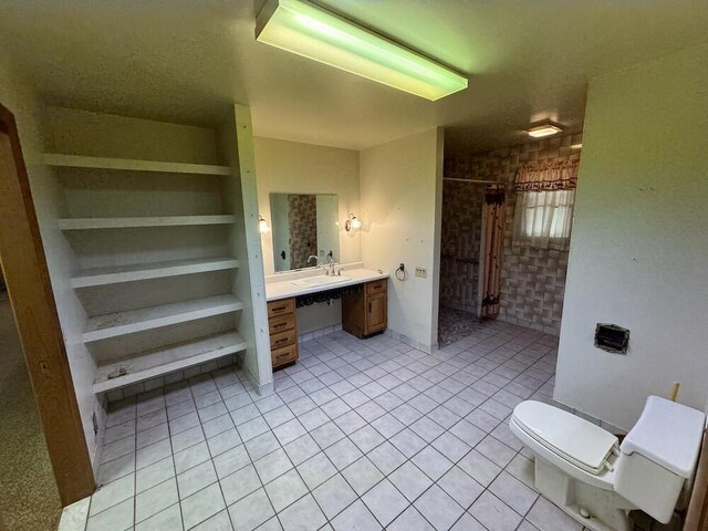 5490 S Harrison Rd, Houghton Lake, MI 48629 - full bath with tile patterned flooring, vanity, curtained shower, toilet, and built in shelves